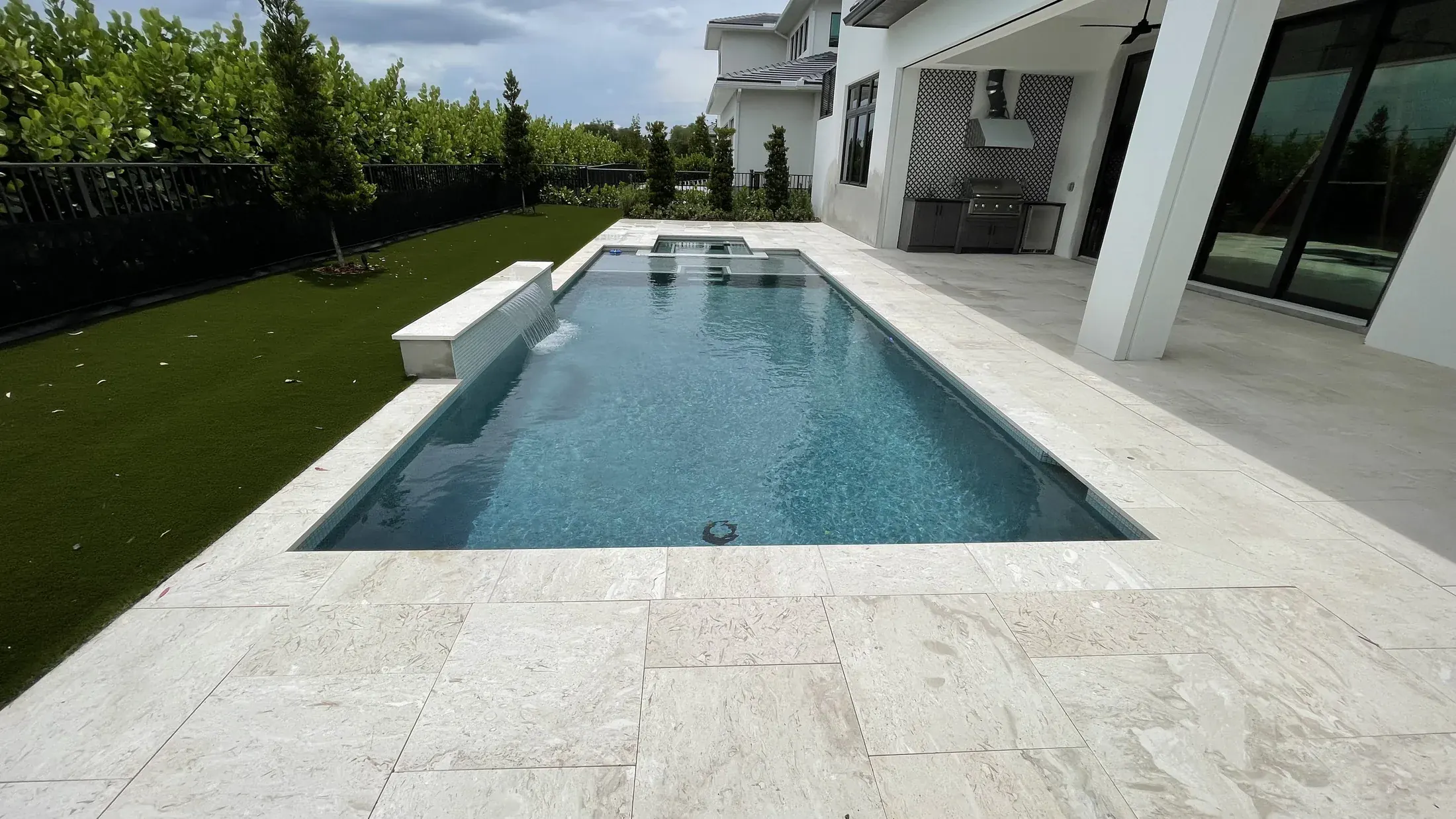 Completed Palm Beach County pool remodeling project with new pool plaster and a light stone deck