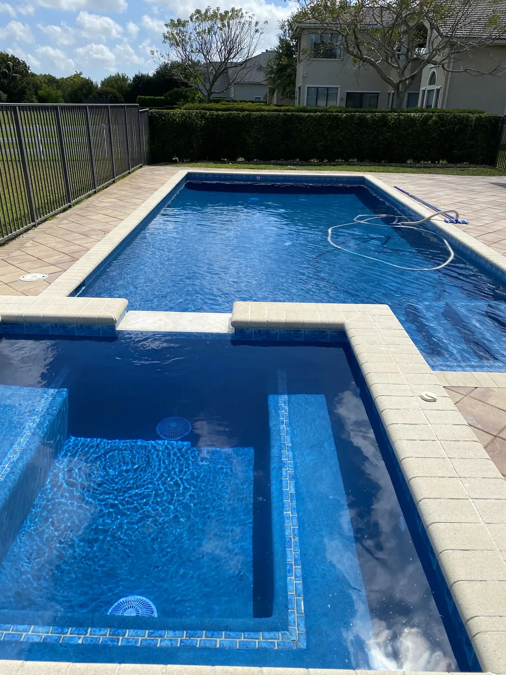Close view of new deep-blue pool plaster beside light coping