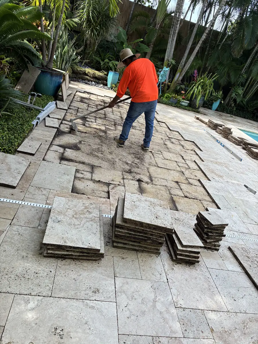 Travertine pavers lifted and staged during a Delray Beach sinking pool deck repair