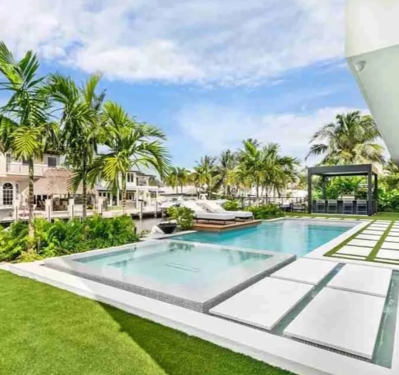Completed modern pool deck with tropical landscaping