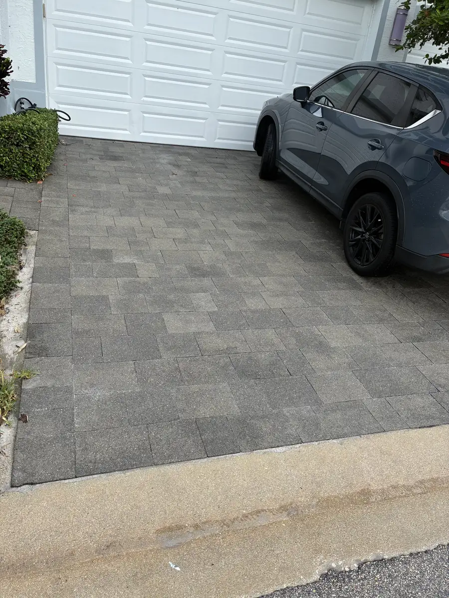 Finished gray paver driveway after localized repair in Boca Raton