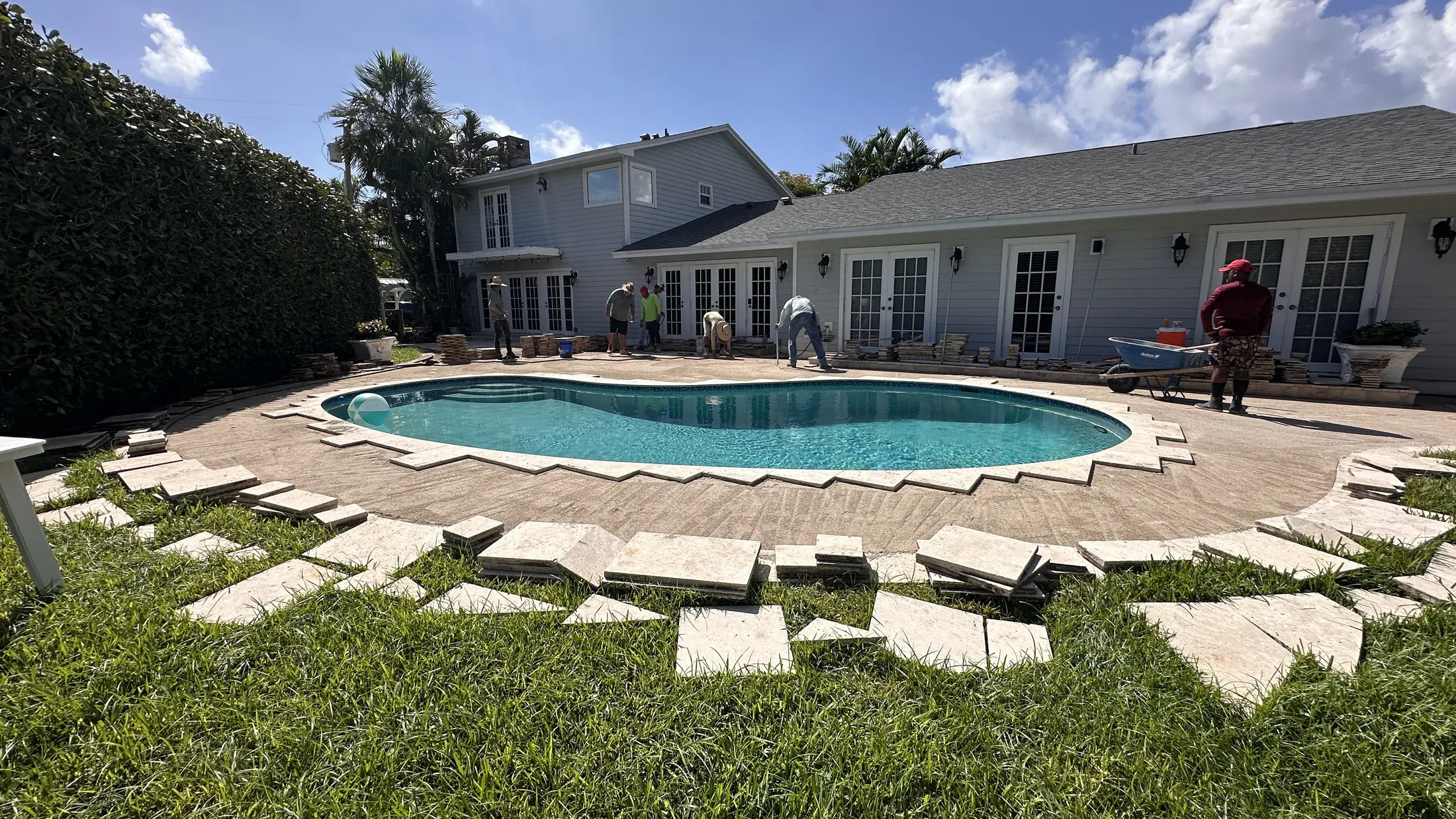 Wide view of a pool deck while pavers were being reset